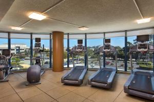 a gym with several treadmills in a building at Embassy Suites San Francisco Airport - South San Francisco in South San Francisco