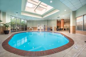a large pool in a large room with a large ceiling at Embassy Suites By Hilton Seattle - Tacoma International Airport in Tukwila