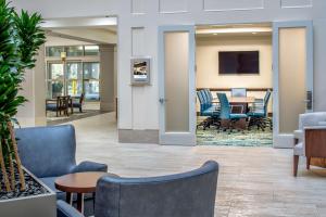 an office lobby with chairs and a table at Embassy Suites By Hilton Seattle - Tacoma International Airport in Tukwila