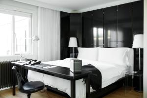a bedroom with a black and white bed and a desk at 101 Hotel, a Member of Design Hotels in Reykjavík