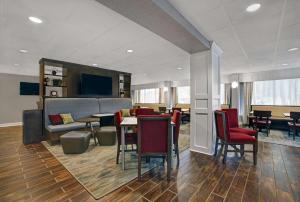 a living room with chairs and tables and a couch at Hampton Inn Salisbury in Salisbury