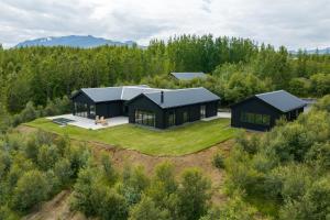 an aerial view of a black house in the forest at Svart Lodge in Akureyri
