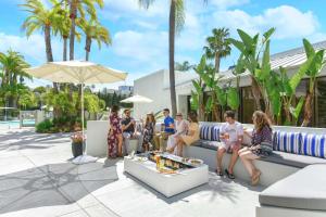 a group of people sitting on a couch on a patio at Hilton Irvine/Orange County Airport in Irvine