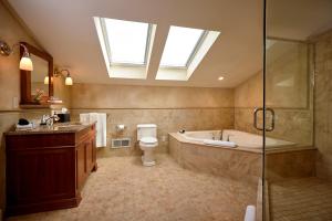 a bathroom with a tub and a toilet and a sink at Mansion Hill Inn in Madison +29 photos