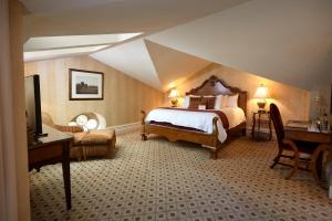 a bedroom with a large bed in a attic at Mansion Hill Inn in Madison