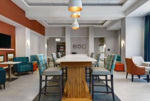 a waiting room with a table and chairs at Hampton Inn & Suites Belleville in Belleville