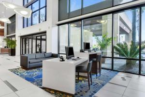 an office with a desk with two computers on it at Embassy Suites by Hilton Anaheim-Orange in Anaheim