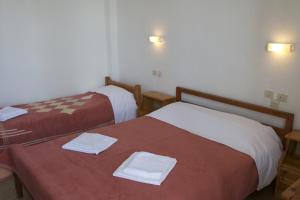 Postel nebo postele na pokoji v ubytování Hotel Sevilli