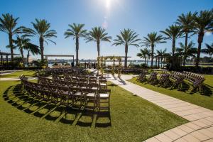 a row of chairs and a wedding venue with palm trees at Hilton San Diego Bayfront in San Diego