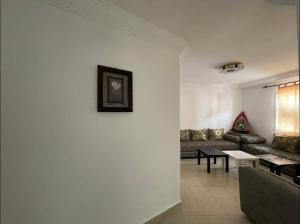 a living room with a couch and a table at Amazing apartment in the heart of El jadida in El Jadida