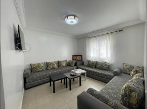 a living room with a couch and a table at Amazing apartment in the heart of El jadida in El Jadida