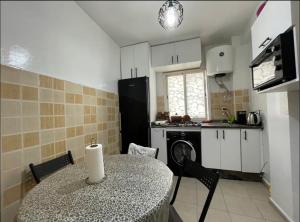 a kitchen with a table and a sink and a stove at Amazing apartment in the heart of El jadida in El Jadida