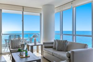 a living room with a view of the ocean at Dharma Home Suites Miami Beach at Monte Carlo in Miami Beach