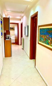 a hallway with a painting on the wall and a kitchen at “Stadium” Apartment in Tirana