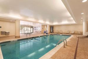 a large swimming pool in a hotel lobby with a large swimming pool at Hampton Inn & Suites Lake George in Lake George