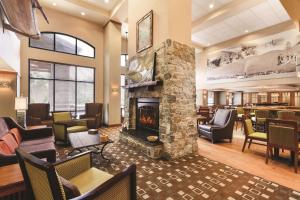 a lobby with a fireplace in a hotel room at Hampton Inn & Suites Lake George in Lake George