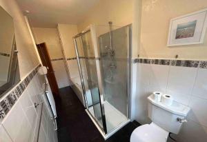 a bathroom with a shower and a toilet at Lovely house & driveway parking in Kidsgrove