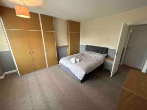 a bedroom with a bed with white pillows on it at Lovely house & driveway parking in Kidsgrove +5 photos