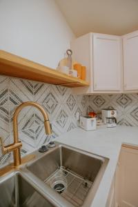 a kitchen with a sink and a counter top at East Downtown Desert Chic Casita-Hot Tub-Pet Friendly-No Pet Fees! in Albuquerque