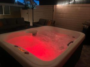a bath tub filled with a red substance at East Downtown Desert Chic Casita-Hot Tub-Pet Friendly-No Pet Fees! in Albuquerque