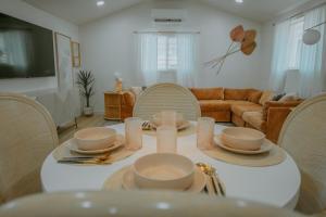 a living room with a white table and chairs at East Downtown Desert Chic Casita-Private Hot Tub-Close to Downtown-Pet Friendly! in Albuquerque