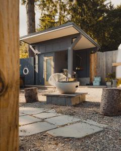 a house with a fountain in the middle of a yard at Dreamy Airstream Hideaway with Hot Tub in Gibsons