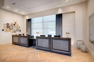 an office with two desks and a large window at Embassy Suites by Hilton Atlanta Buckhead in Atlanta
