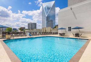 a swimming pool on the roof of a building with a skyscraper at Embassy Suites by Hilton Atlanta Buckhead in Atlanta