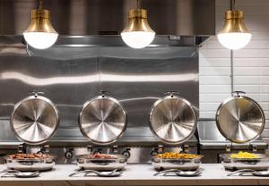 a kitchen with four bowls of food on a counter at Embassy Suites by Hilton Atlanta Buckhead in Atlanta