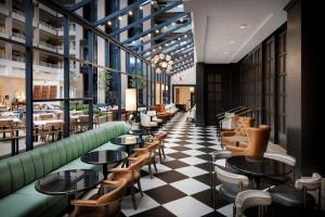 a restaurant with tables and chairs on a checkered floor at Embassy Suites by Hilton Atlanta Buckhead in Atlanta +41 photos