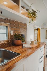 a kitchen with a sink and a wooden counter top at Dreamy Airstream Hideaway with Hot Tub in Gibsons