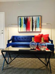 a blue couch with two bowls on a coffee table at StayRafa At 261 4R in Philadelphia