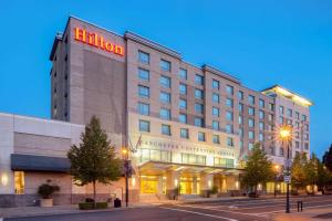 a hotel with a sign on the front of it at Hilton Vancouver Washington in Vancouver