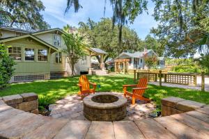 a backyard with two chairs and a fire pit at Flagler Cottage - 1 Block to Historic District in Saint Augustine