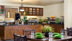 a kitchen with a table with green dishes on it at Homewood Suites by Hilton Bozeman in Bozeman