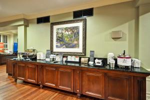 a large wooden counter in a room with a picture on the wall at Hampton Inn Charleston-Historic District in Charleston