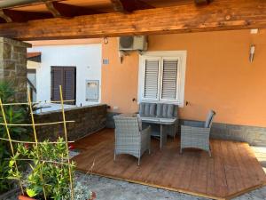 a patio with chairs and a table and a window at Apartment Emma in Piran