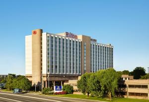 a large hotel building with a road in front of it at Hilton Newark Airport in Elizabeth