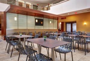 a restaurant with tables and chairs in a room at Embassy Suites by Hilton San Diego La Jolla in San Diego