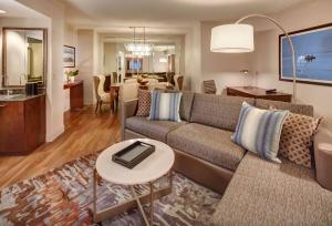 a living room with a couch and a table at Embassy Suites by Hilton San Diego La Jolla in San Diego