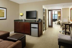 a hotel room with a living room with a television and a living room at DoubleTree by Hilton Washington DC – Crystal City in Arlington