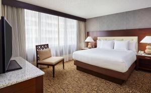 a hotel room with a large bed and a television at DoubleTree by Hilton Washington DC – Crystal City in Arlington