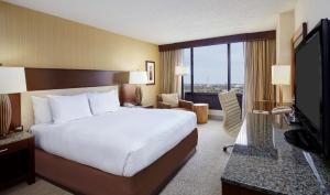 a hotel room with a large bed and a television at DoubleTree by Hilton Washington DC – Crystal City in Arlington