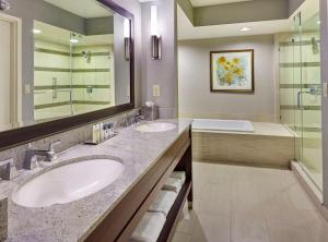 a bathroom with two sinks and a shower at DoubleTree by Hilton Washington DC – Crystal City in Arlington