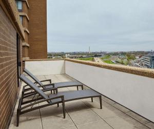 two chairs sitting on the balcony of a building at DoubleTree by Hilton Washington DC – Crystal City in Arlington