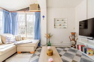ein Wohnzimmer mit einem Sofa und einem TV in der Unterkunft Oasis en Quilmes con Parking Privado in Quilmes