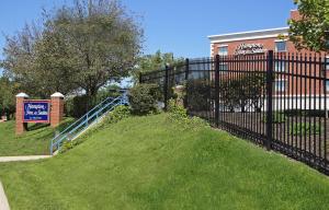 a black fence in front of a building at Hampton Inn & Suites By Hilton - Rockville Centre in Rockville Centre