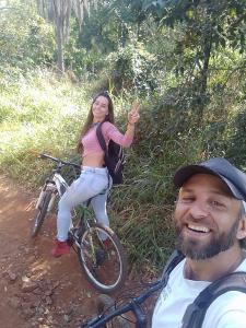 a man and a woman on a bike on a trail at Recanto das Araras, Transcendental in Bonito