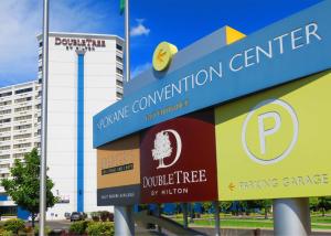 a sign for a convention center in front of a building at DoubleTree by Hilton Spokane City Center in Spokane
