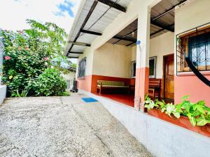 a porch of a house with a bench on it at Casa independiente in Puerto Ayora